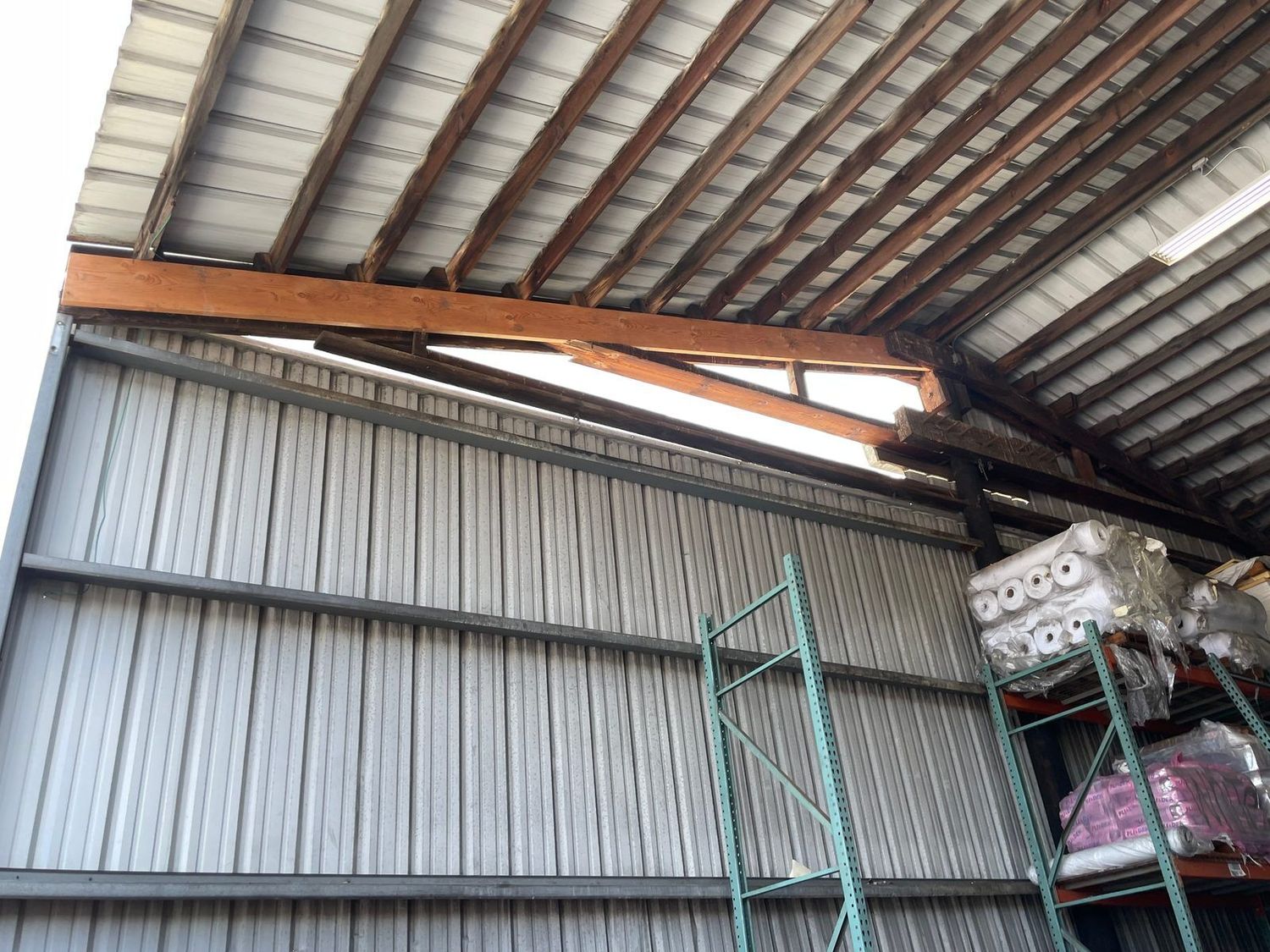 Building-scale structural steel framing on a commercial roof, seen from ground level