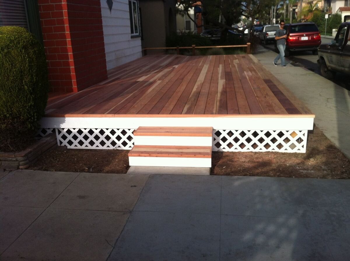 Level landing partway along the ramp with a step-down to the sidewalk