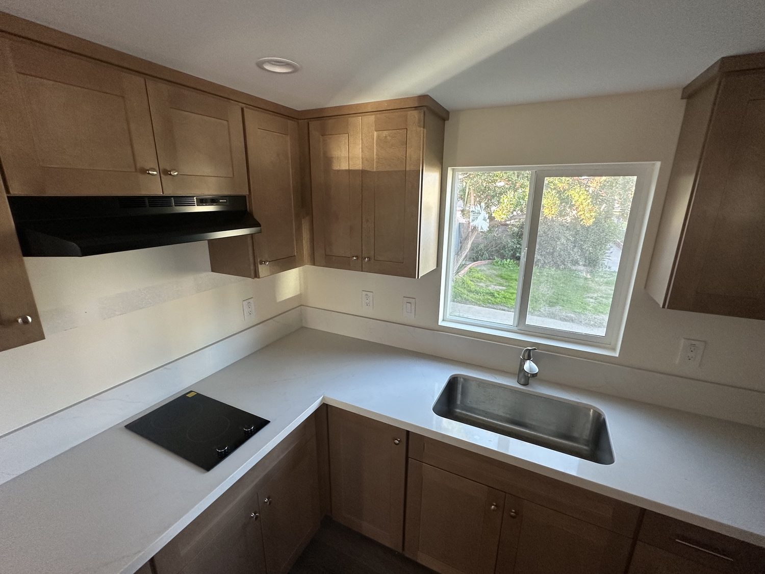 Kitchen in the Lee Residence ADU in Bellflower, with shaker cabinets and white counters