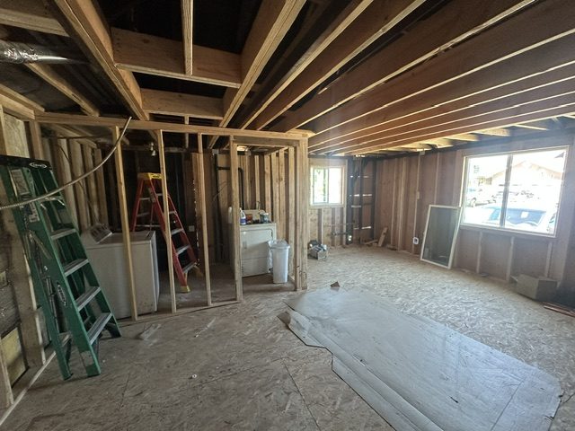 Interior walls framed on the new subfloor, with a new window in the far wall