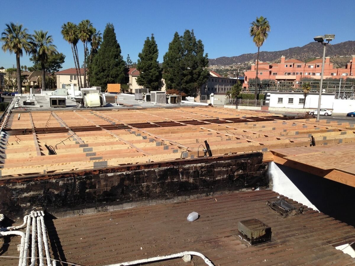Roof stripped back to the joists across the length of the building