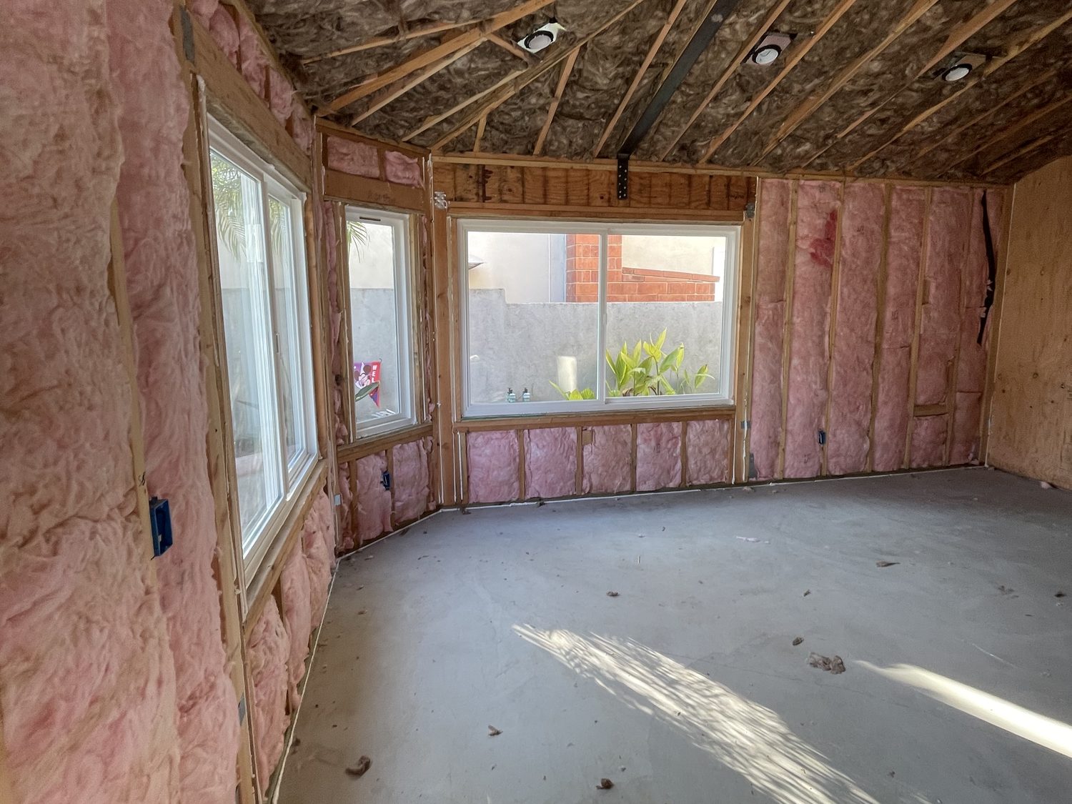 Addition room with walls and ceiling insulated, before drywall