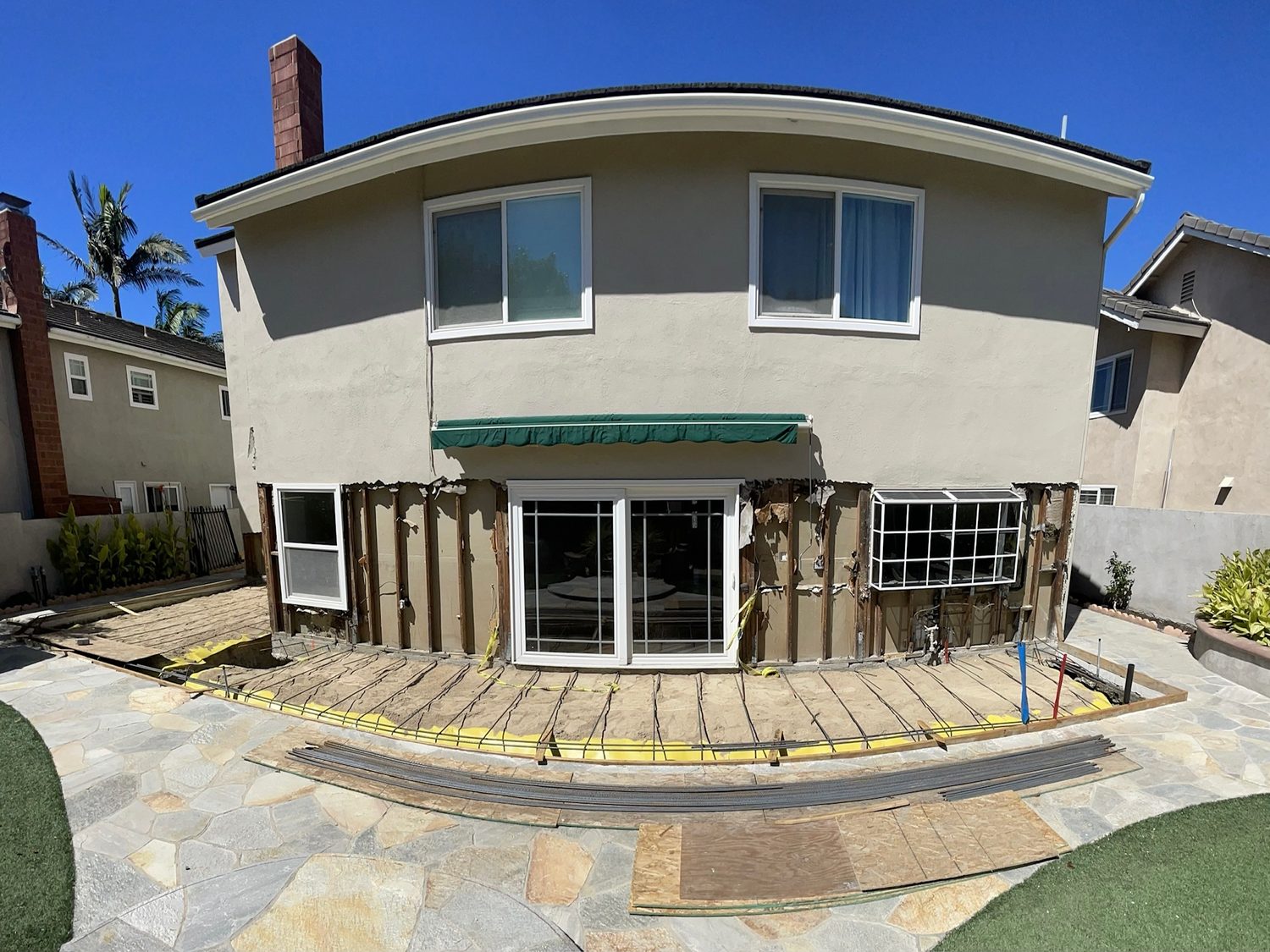Back of the house opened up, with forms laid out on the patio for the addition