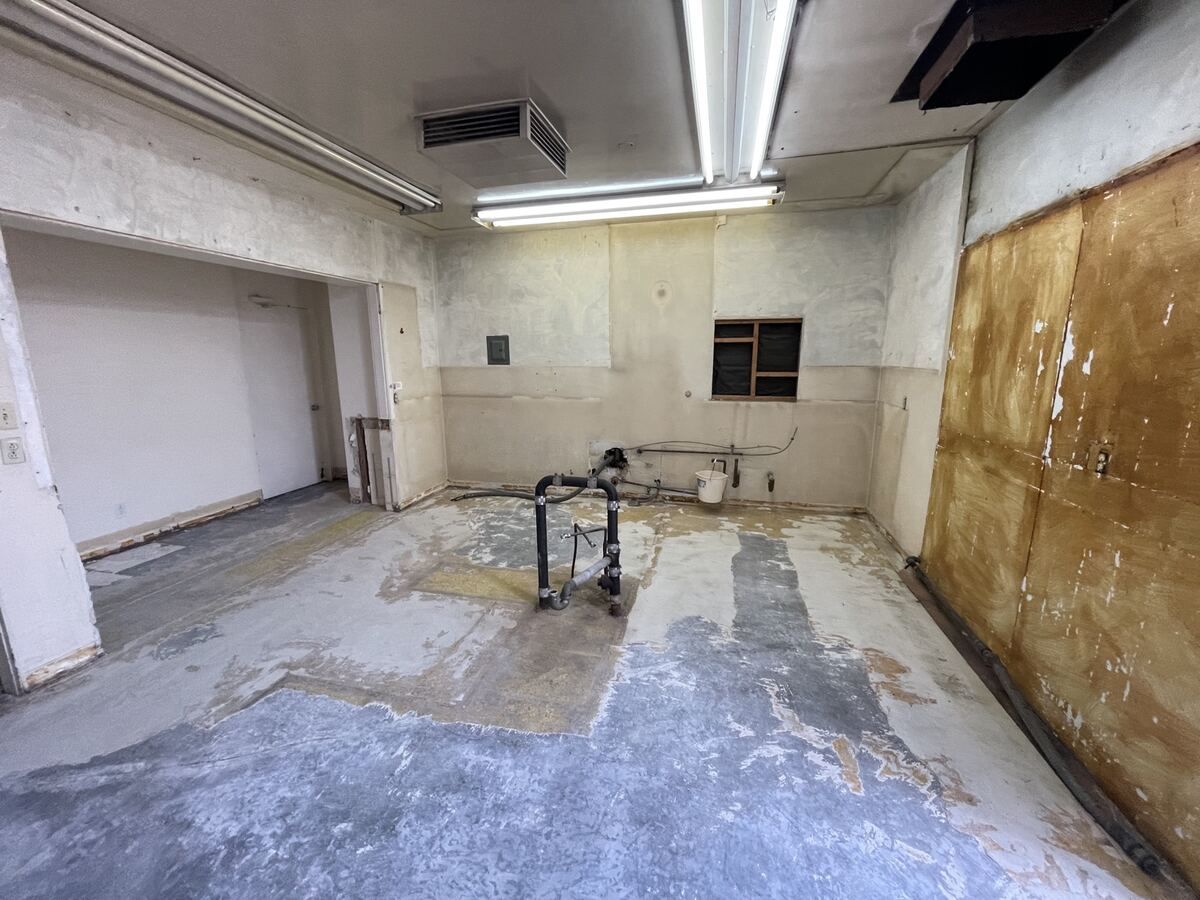 Church kitchen stripped to bare slab and walls before rebuild