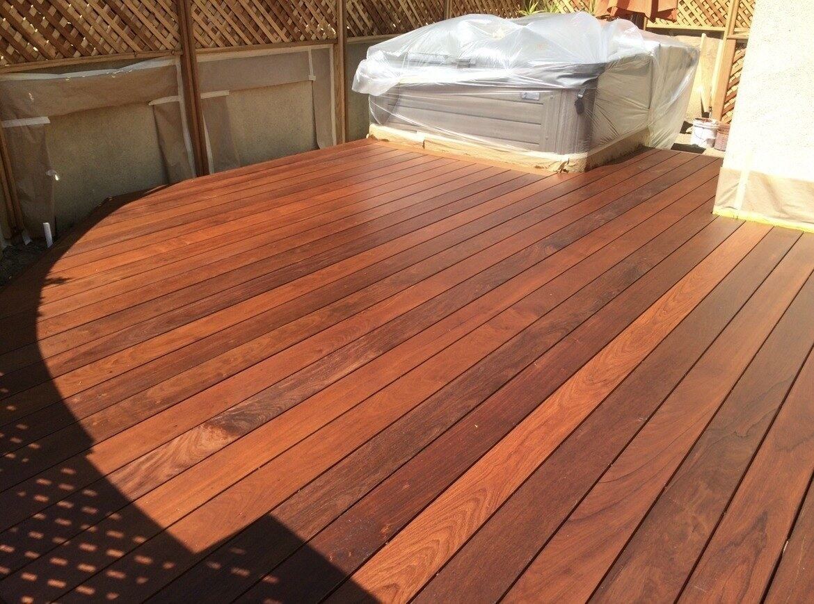 Freshly finished Ipe hardwood deck with a curved edge, laid tight and oiled
