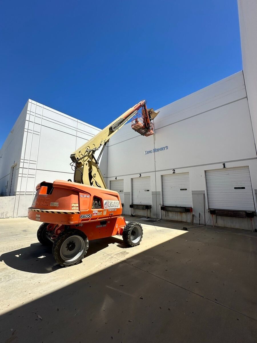 Boom lift reaching the full height of the tilt-up wall