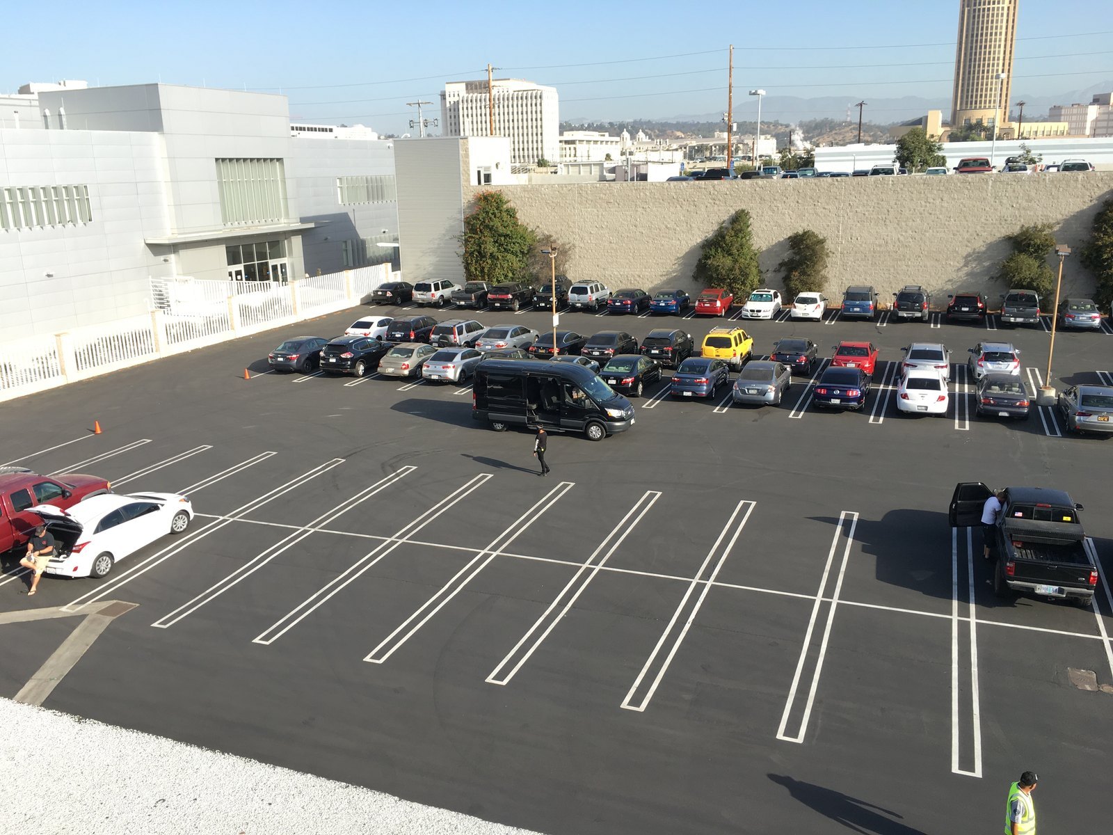 Elevated view of the resurfaced lot with sharp new white stall lines and cones still out