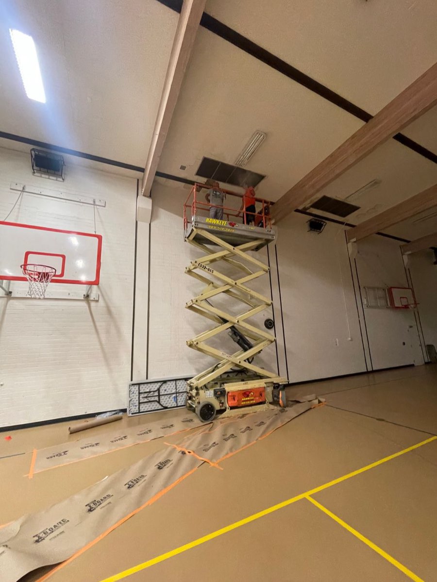 HVAC installation in progress at Nishi Hongwanji gymnasium using scissor lift