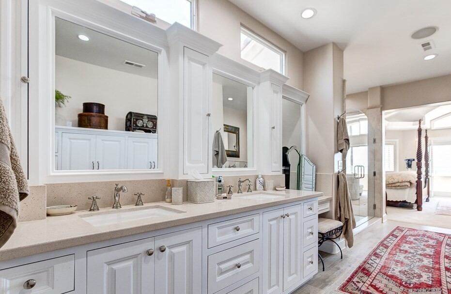 Double vanity with framed mirrors and stone counters